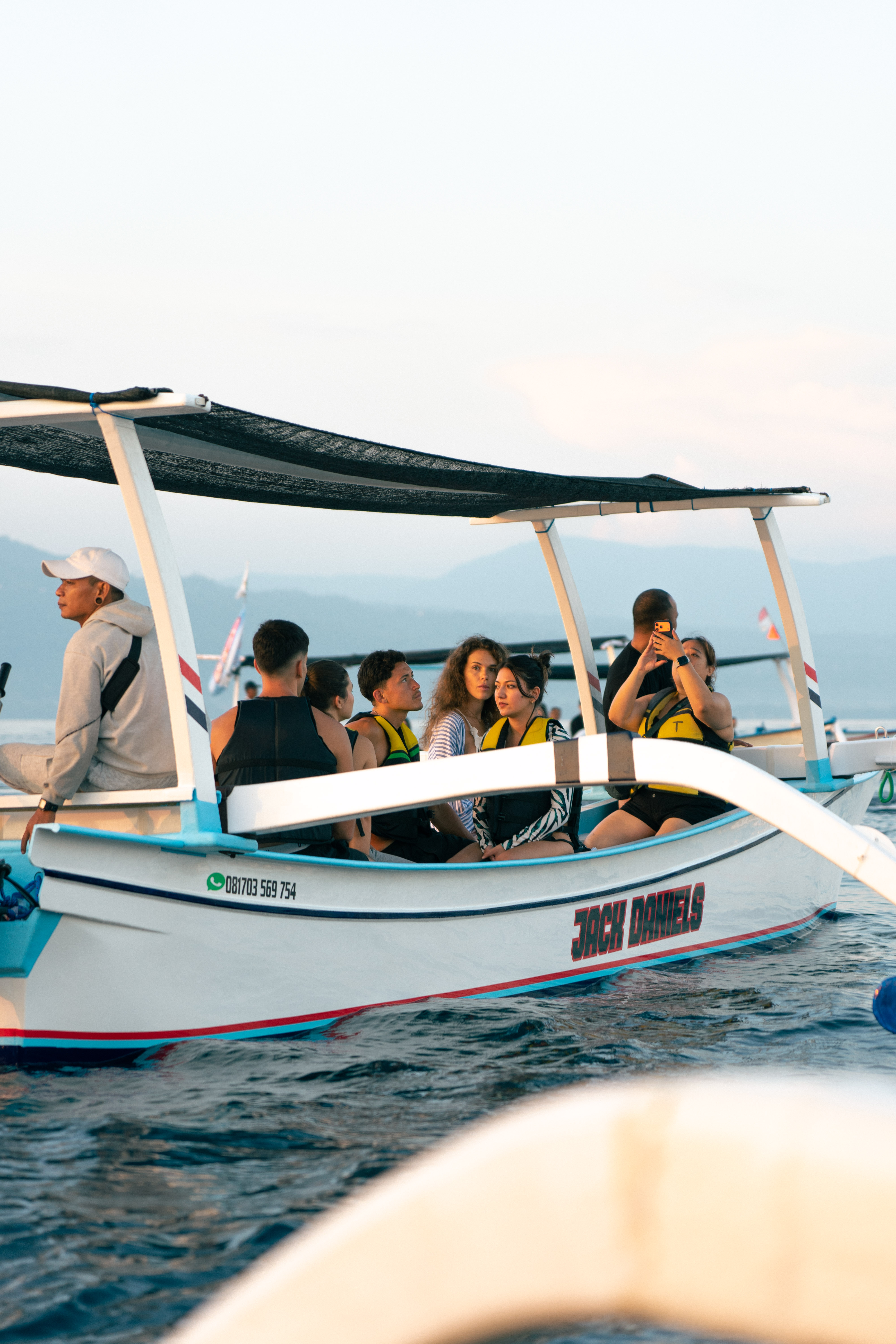 Group on outrigger boat with life vests for Lovina dolphin watching