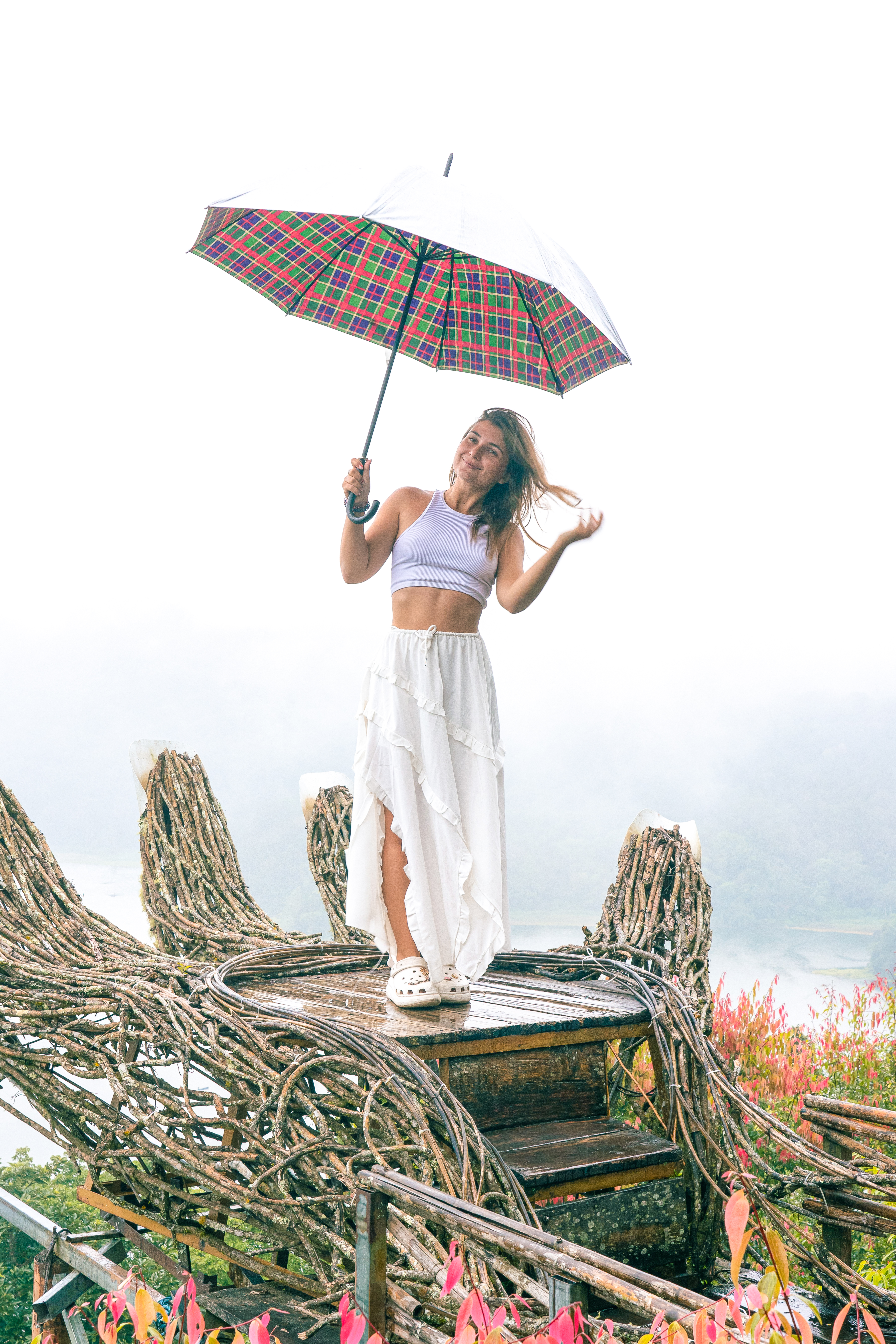 Traveller with umbrella on iconic Wanagiri Hidden Hill platform