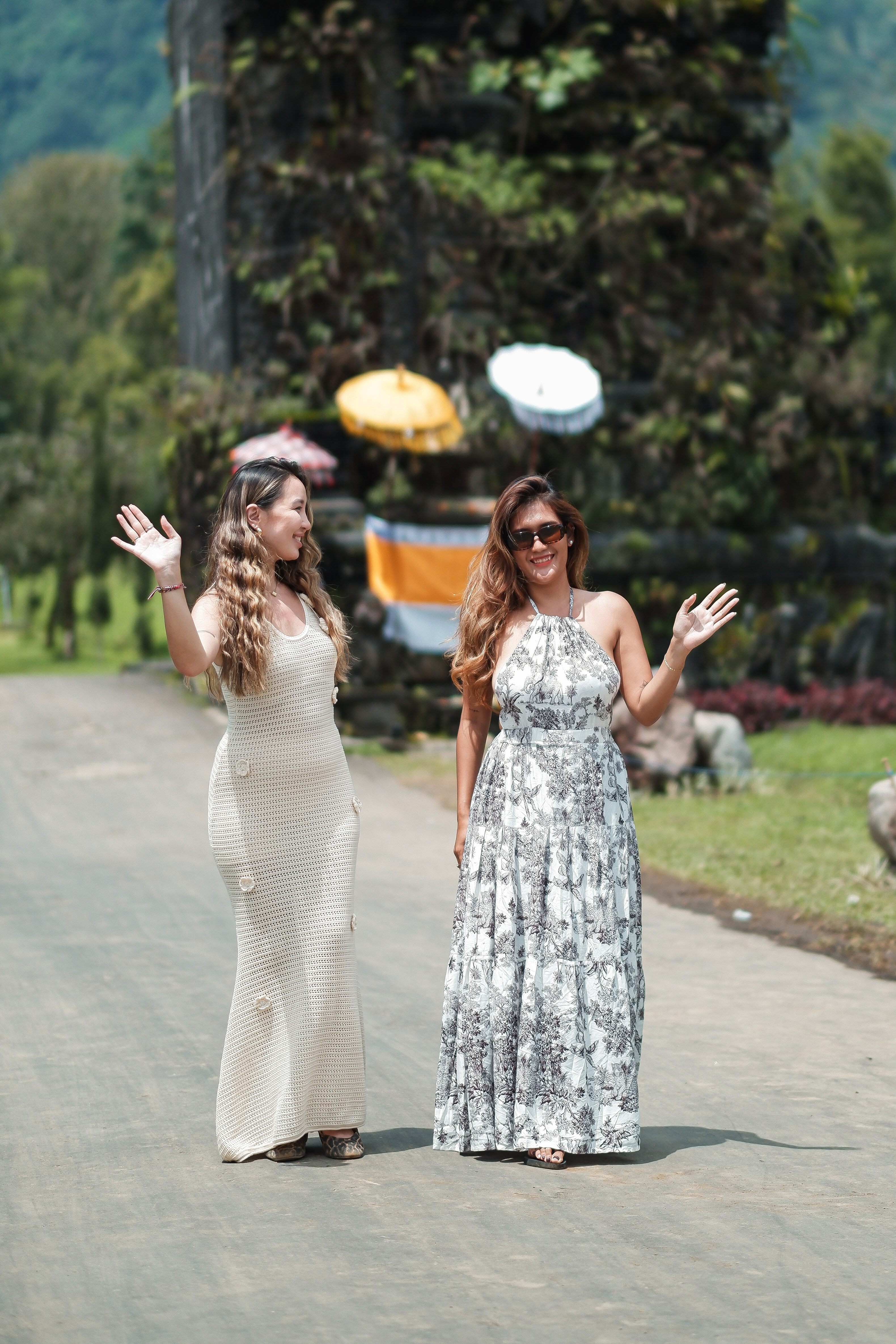 Two friends waving at the iconic Handara Gate in North Bali