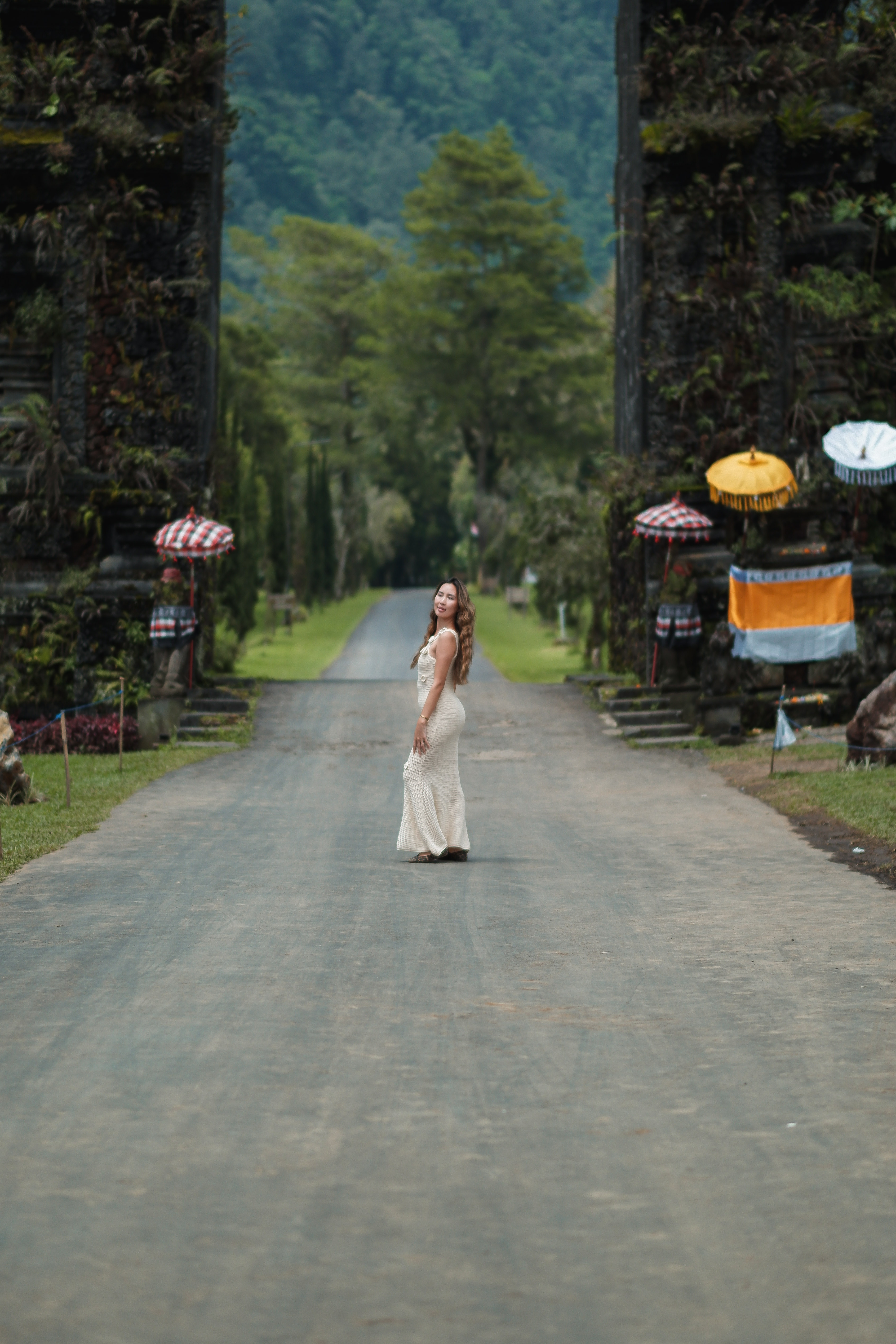 Solo traveller posing at Handara Gate, lake highland landscape