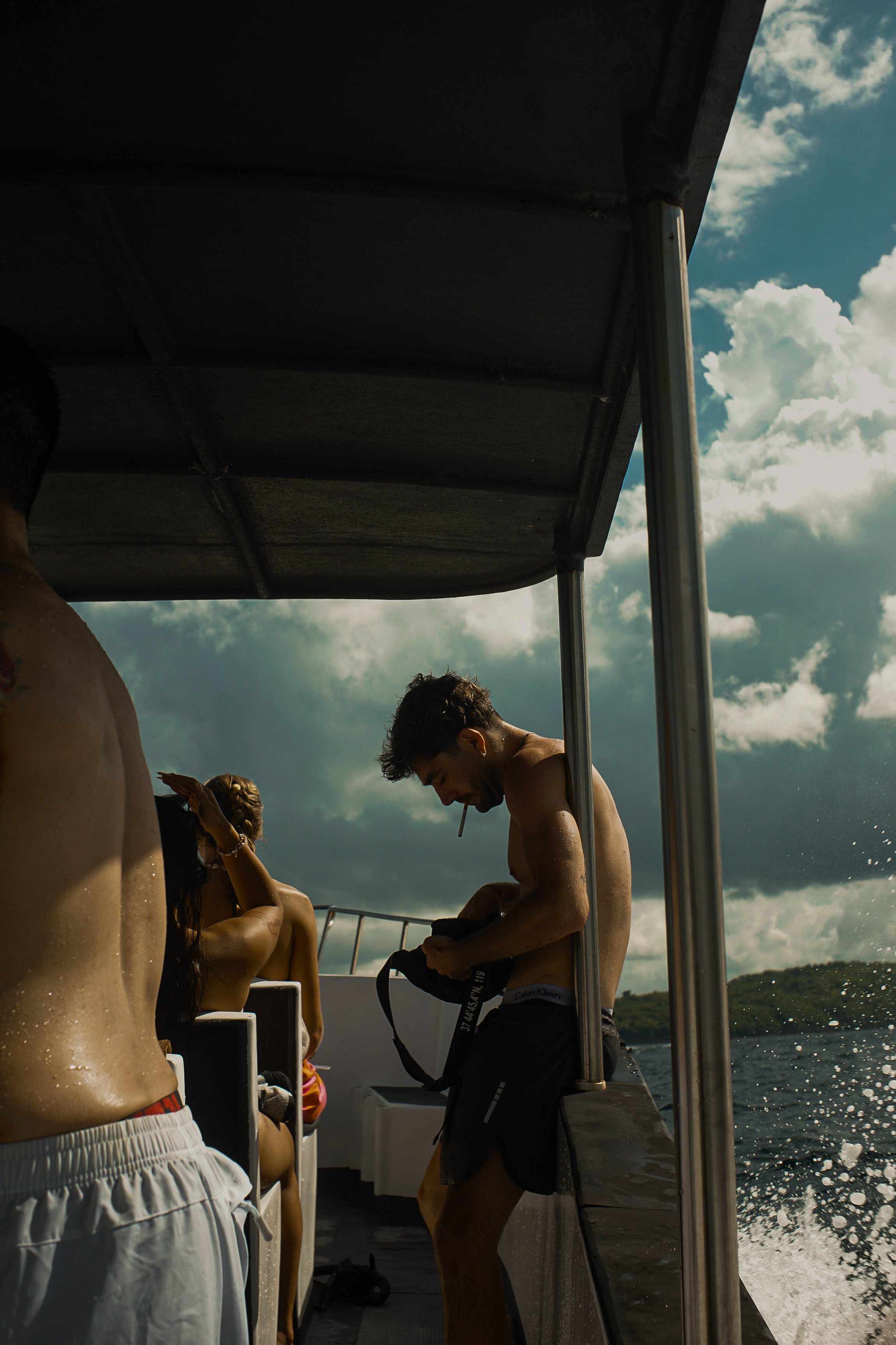 Snorkeler preparing gear on the boat at sunny Nusa Penida