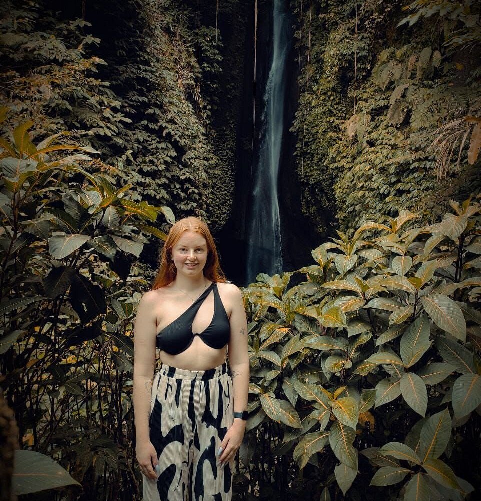 Leke-leke waterfall with traveller experiencing the cleansing flow