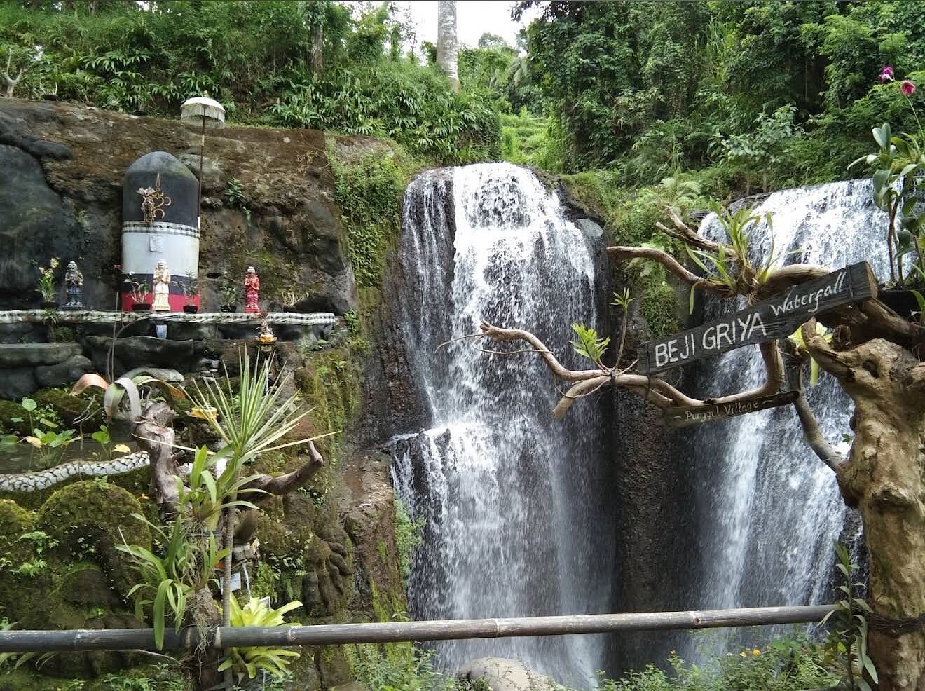 Beji Griya waterfall with shrine and ceremonial offerings