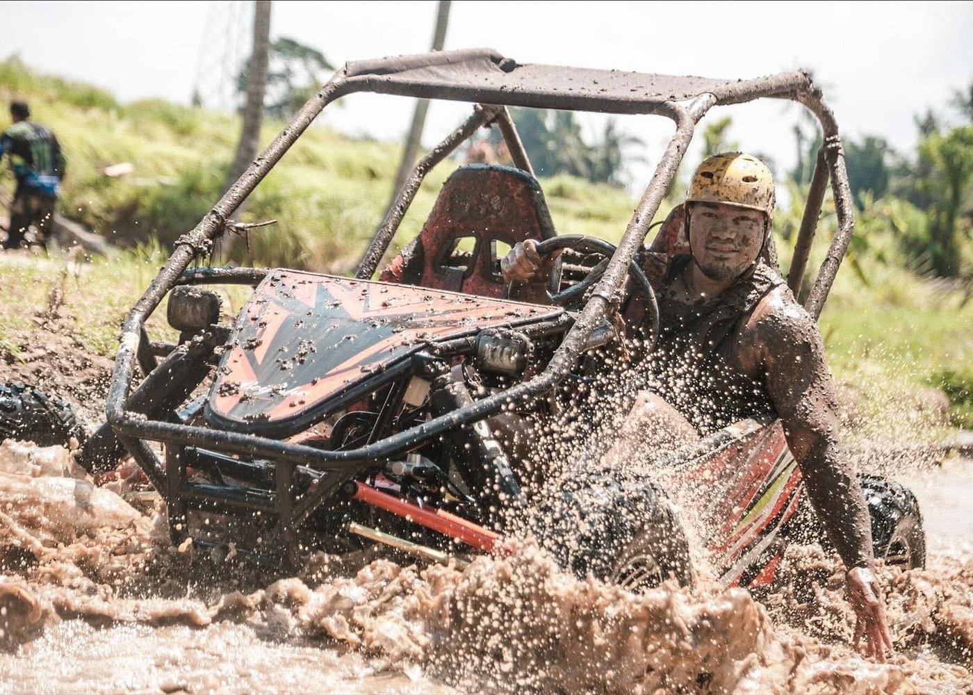 Buggy driver speeding through palm-lined Bali jungle track