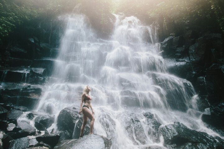 Tibumana waterfall plunging into a forest pool