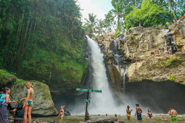 Tukad Cepung waterfall with sunbeams piercing the cave