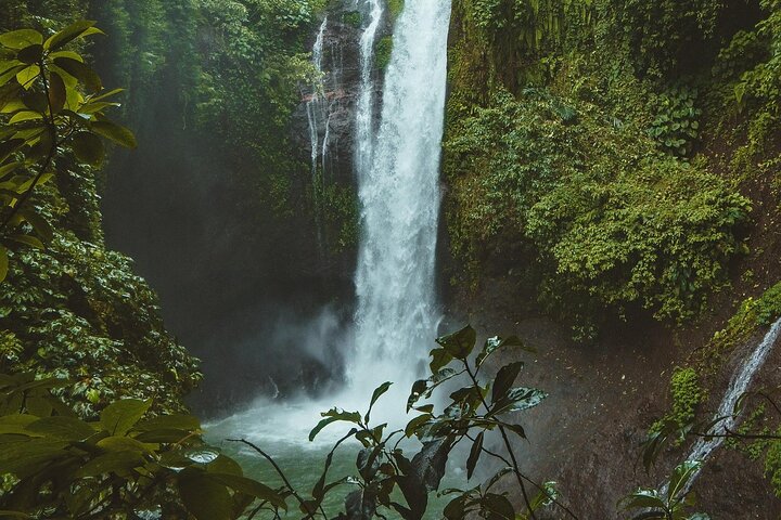 Ulu Petanu waterfall surrounded by tropical greenery