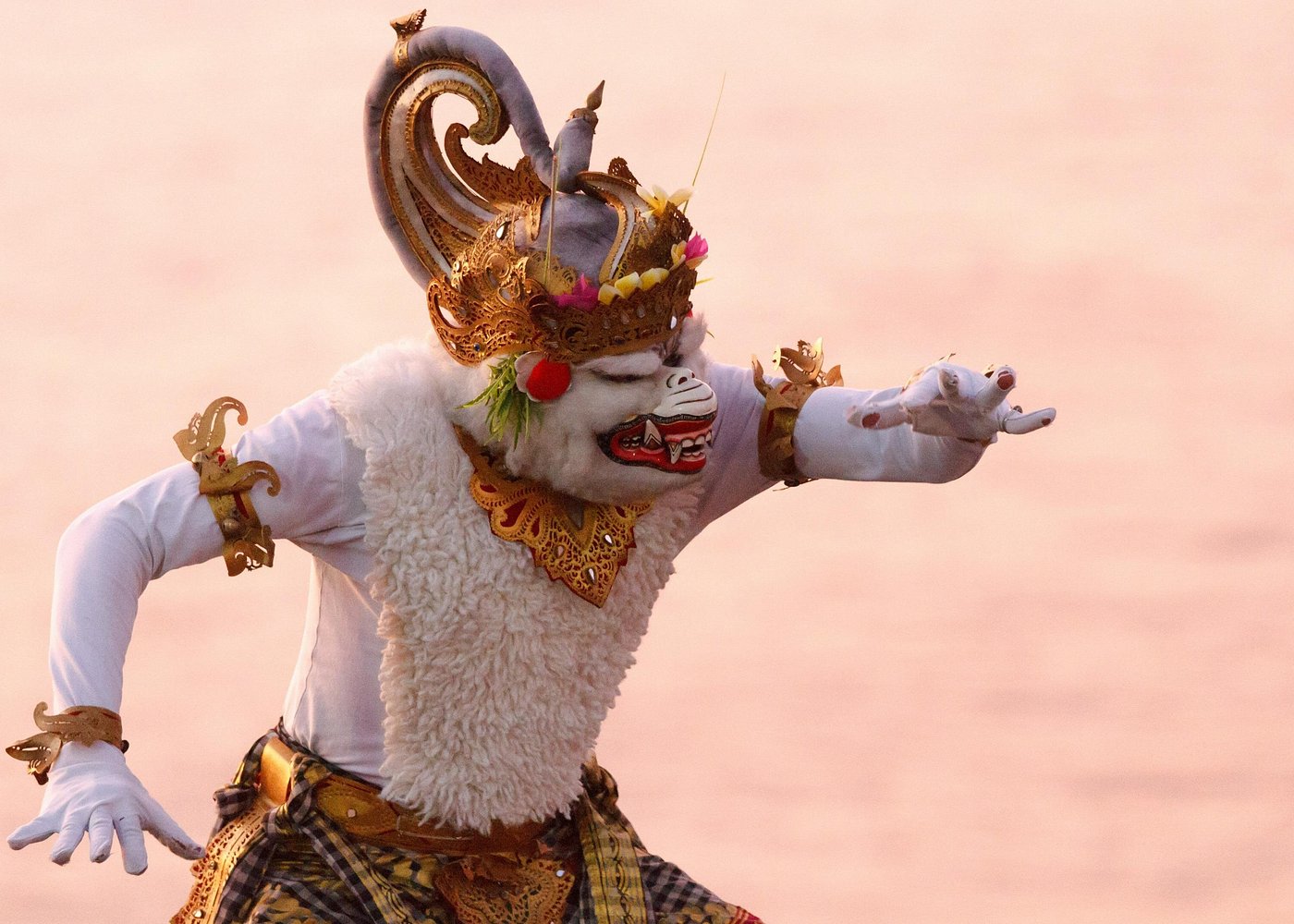 Traditional Balinese Kecak performer in elaborate gold costume