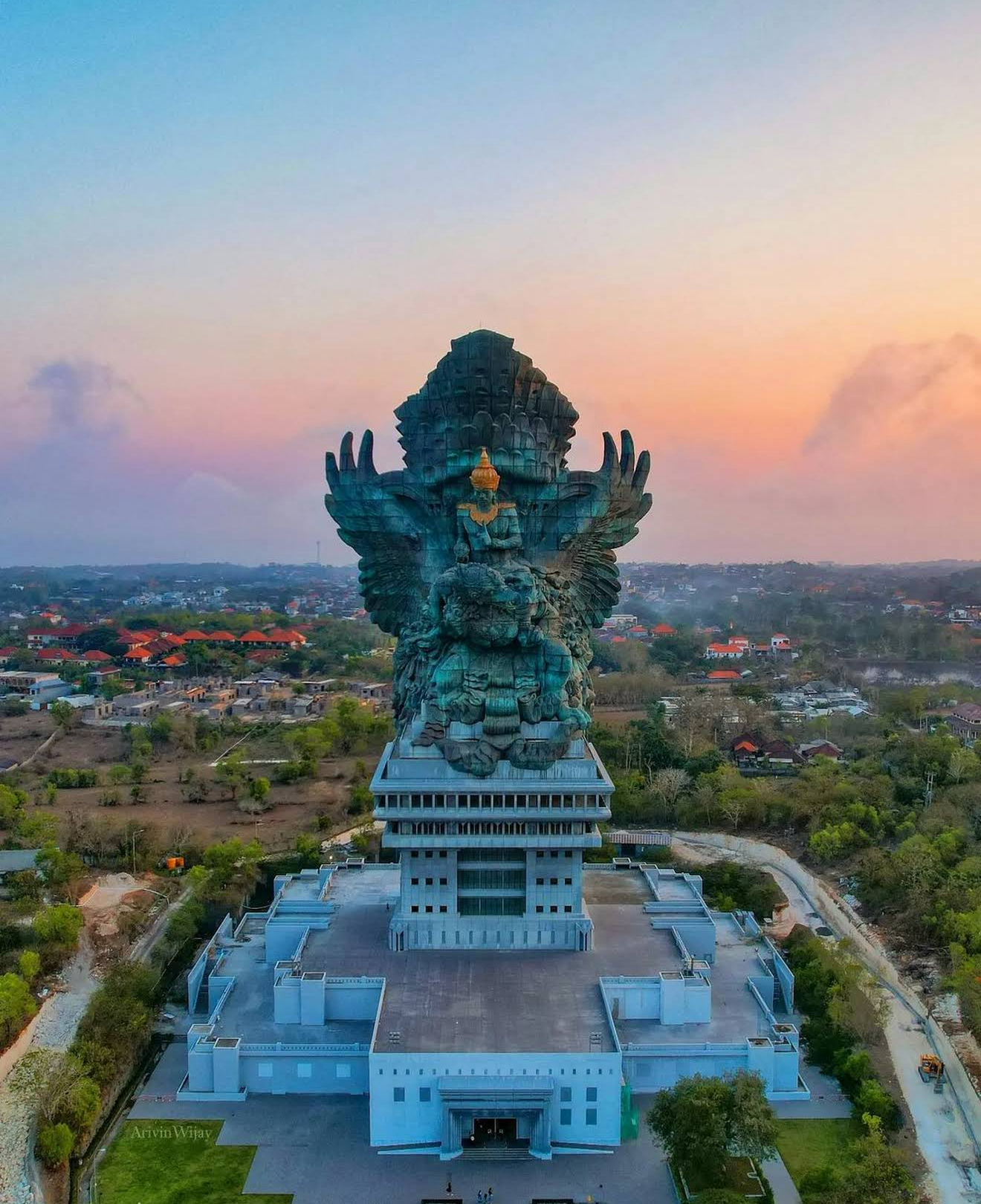 Uluwatu cliff temple silhouetted against the Indian Ocean at sunset